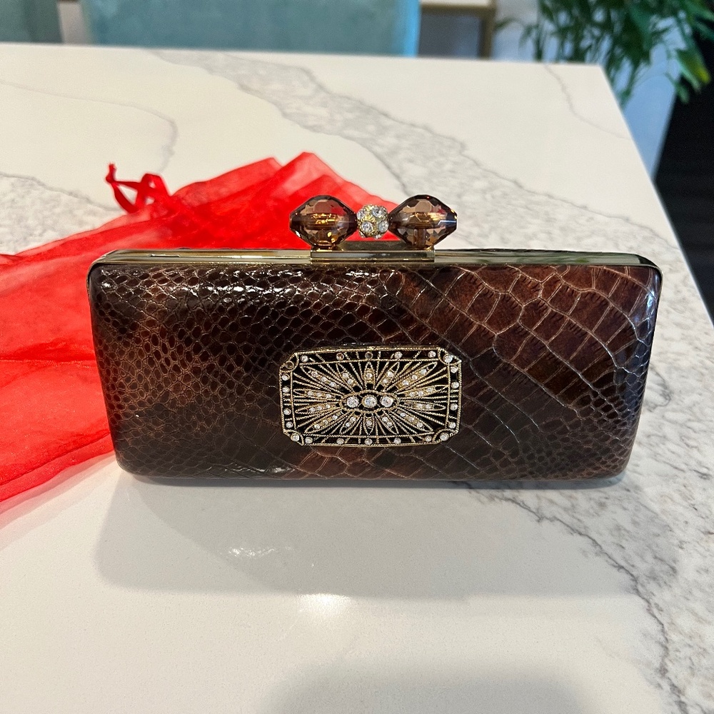 Leather Clutch with Sparkling crystal pattern and opening on the top.